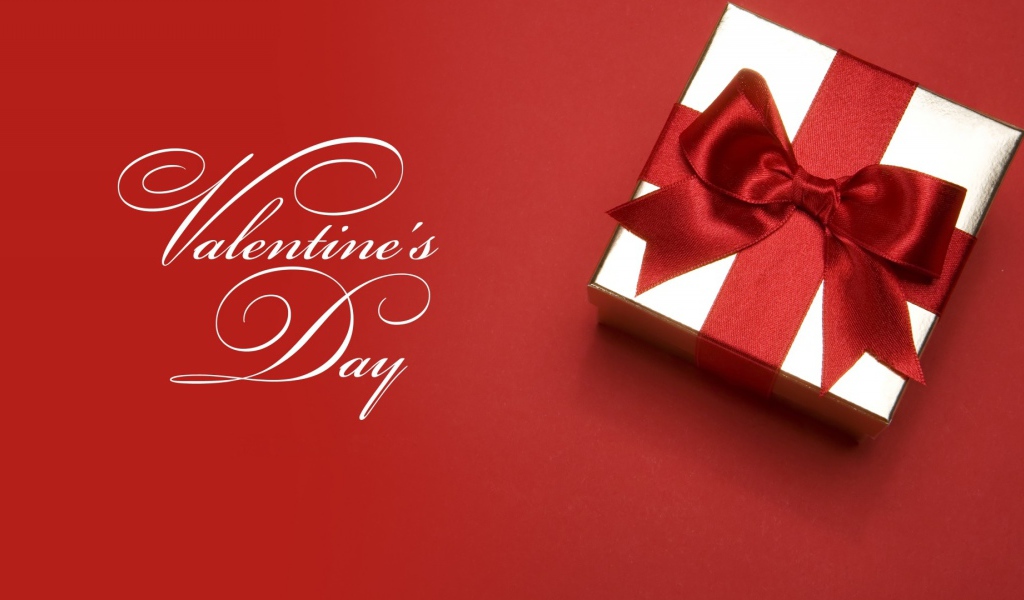 Подарок с красным бантом ко Дню Святого Валентина 