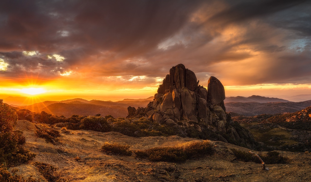 Скала в лучах восходящего солнца 