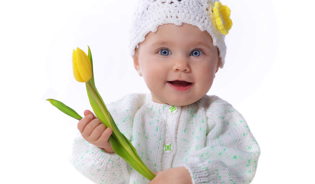 Голубоглазая маленькая девочка с желтым тюльпаном в руках