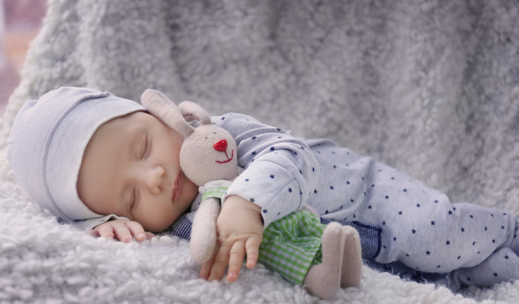 Милый спящий ребенок с игрушкой