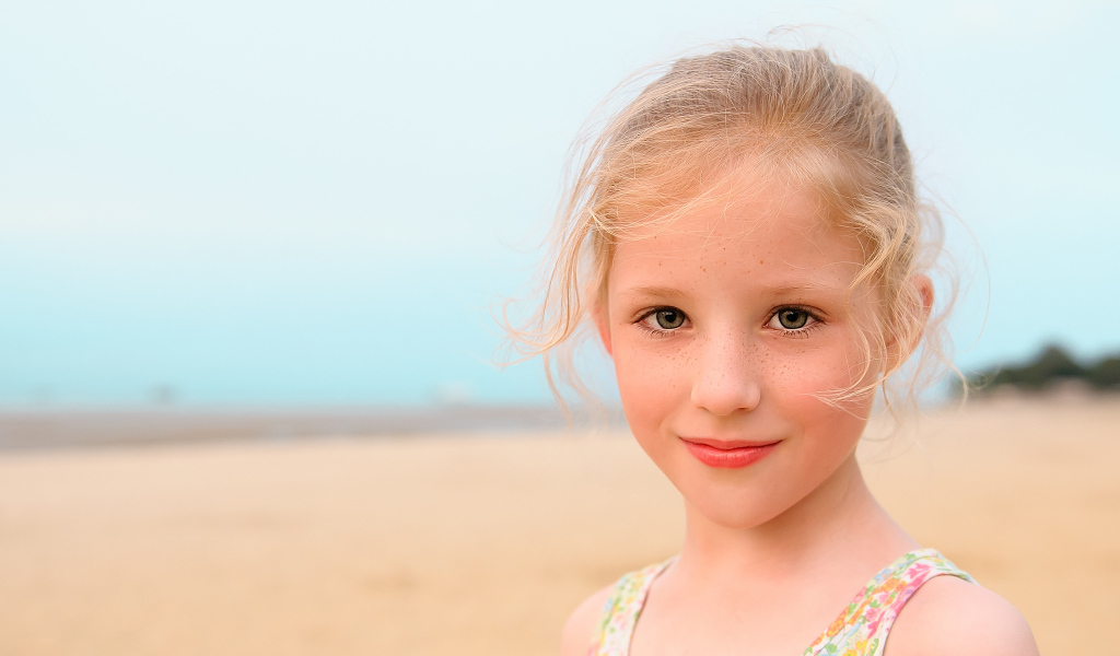 Маленькая красивая девочка с веснушками на лице