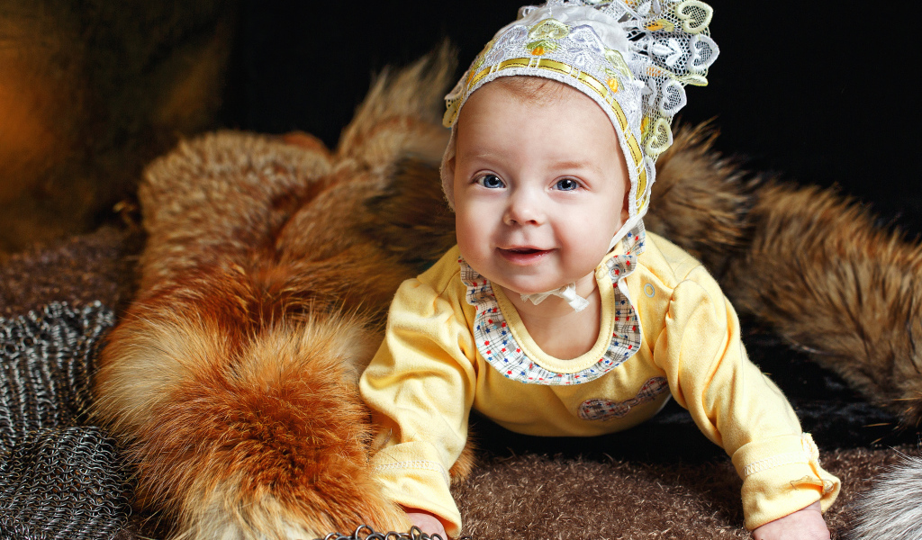 Улыбающаяся голубоглазая девочка в шапке