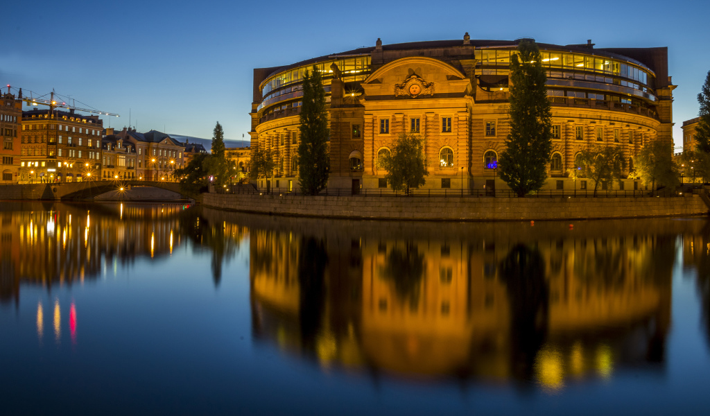 A beautiful building in the evening lights is reflected in the water, Stockholm. Sweden