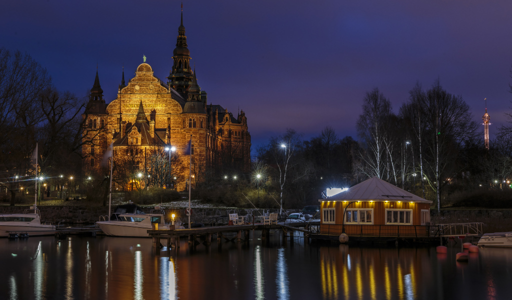 Храм в свете ночных фонарей у причала на реке, Стокгольм. Швеция