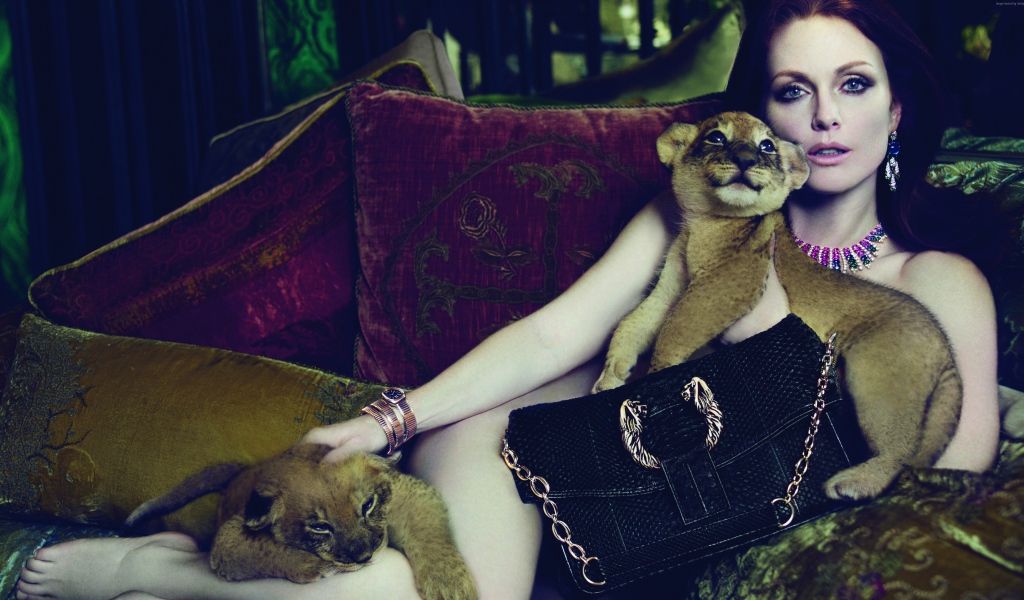 Актриса Джулианна Мур лежит на диване с маленькими львятами