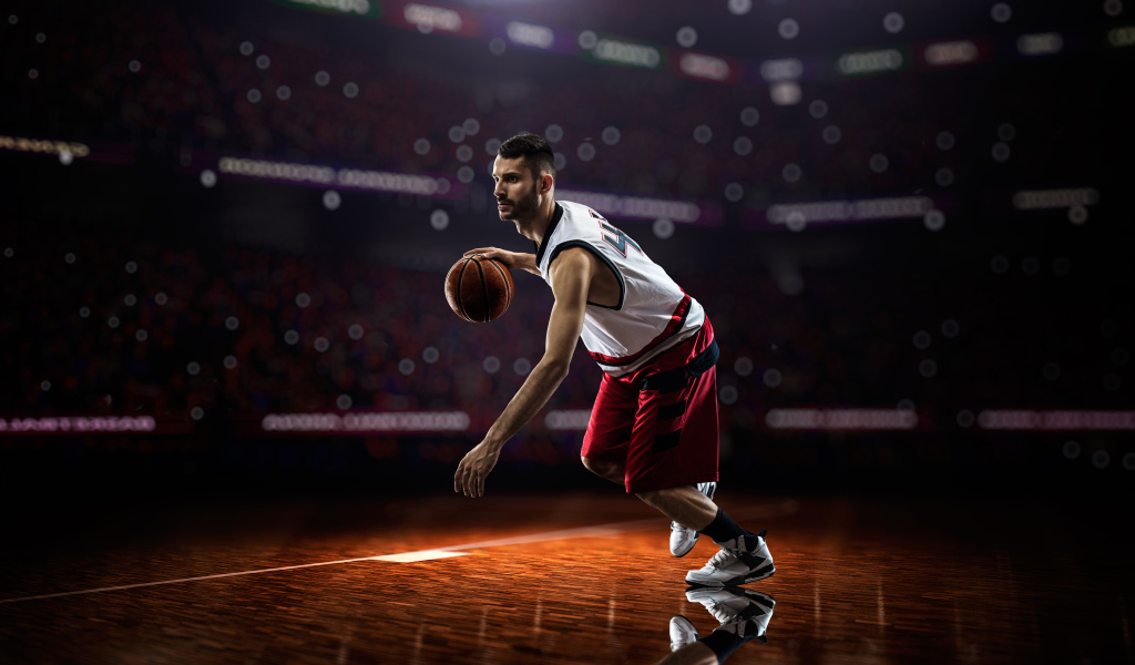 Basketball player with a ball playing on the field