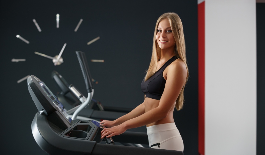 Girl athlete on the treadmill