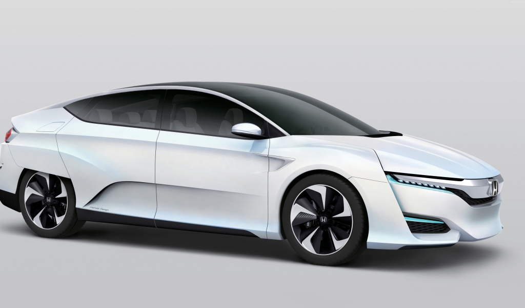 Белый электромобиль  Honda FCv на сером фоне