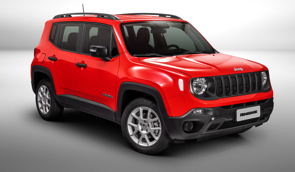 Красный автомобиль Jeep Renegade Sport на сером фоне