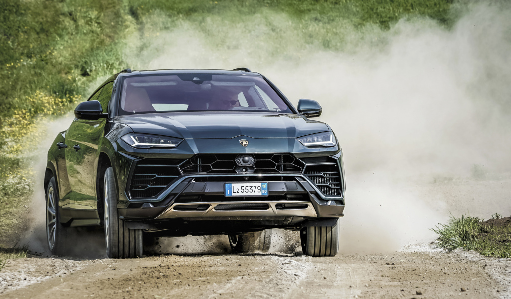 SUV Lamborghini Urus 2018 on the road in the dust
