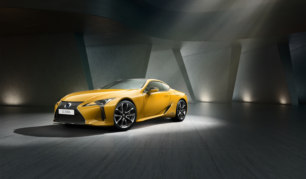 Желтый автомобиль Lexus LC 500 в сером здании
