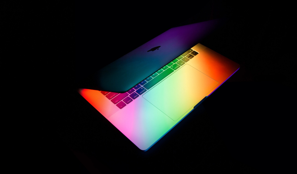 Открытый MacBook Apple  на черном фоне