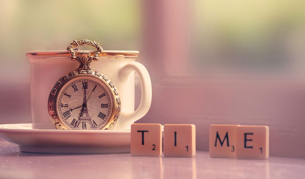 Часы с чашкой на столе с кубиками 