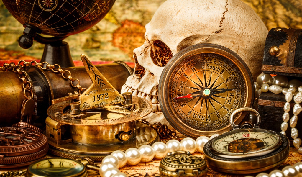 Череп, бинокль, компас, жемчуг и старинные часы на столе