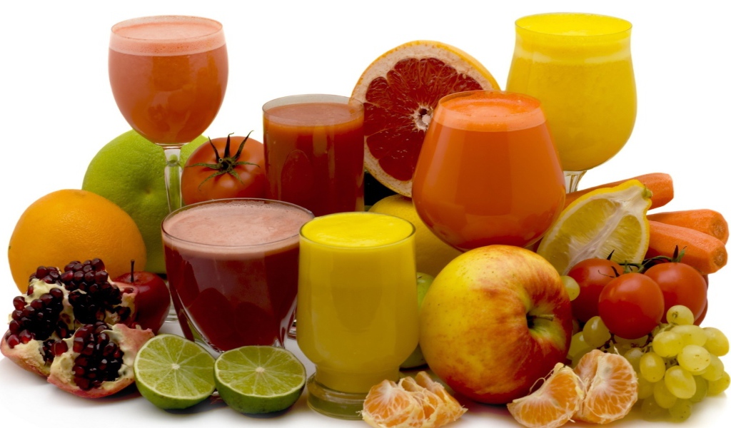 Different fresh juices on a white background with fruits