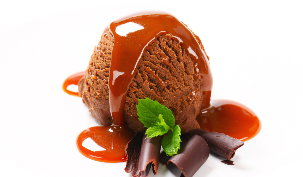 Шарик шоколадного мороженого с джемом на белом фоне 