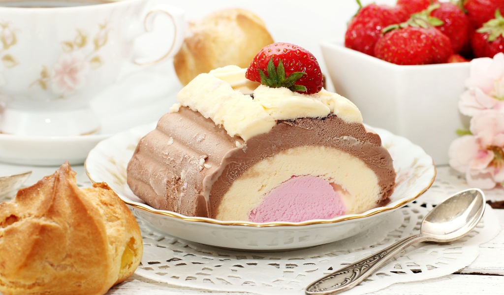 Appetizing ice cream on the table with eclair and strawberries