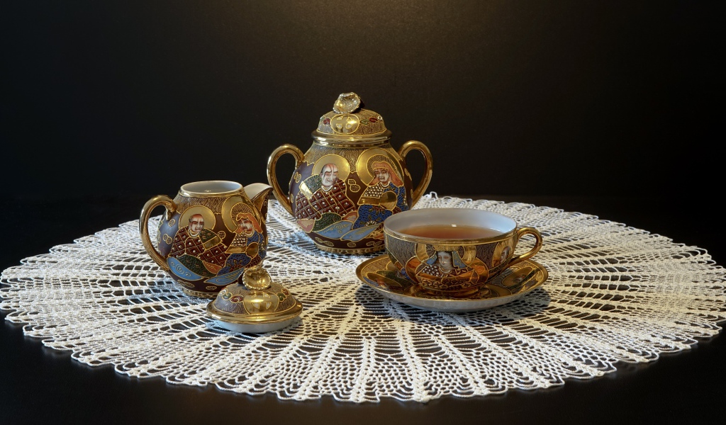 Красивый чайный сервиз на столе с белой салфеткой