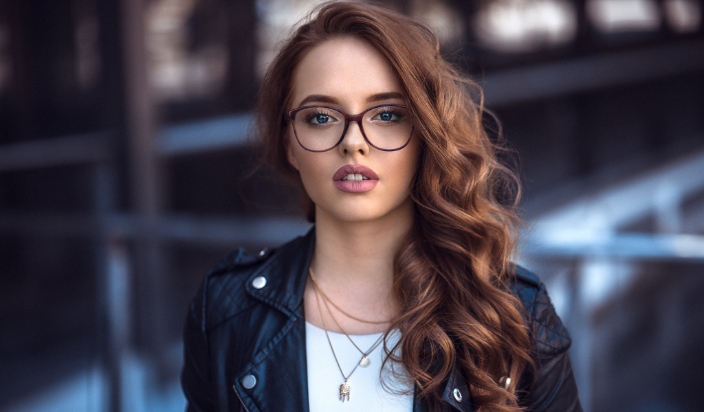 Girl in a black jacket with glasses