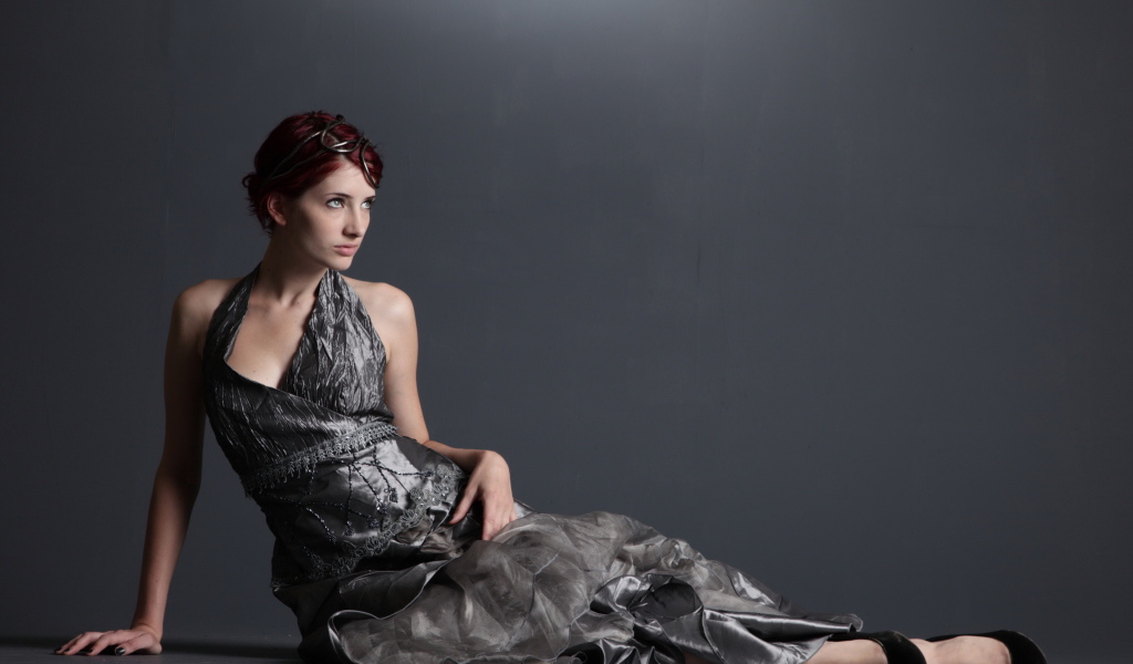 American model Susan Coffey in a beautiful dress on a gray background
