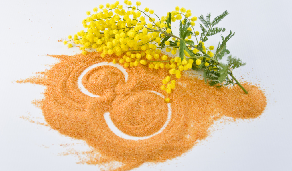 Цифра 8 на песке с веткой мимозы на Международный женский день 8 марта