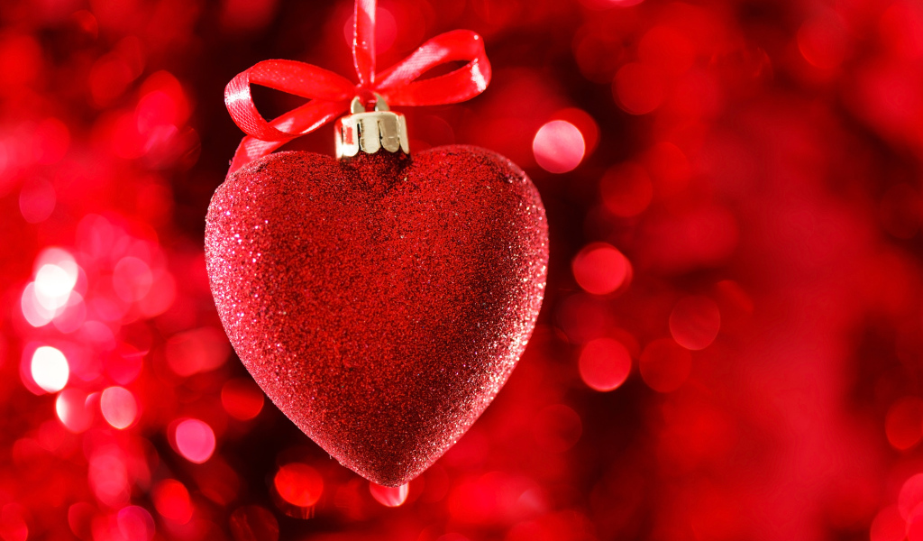 Красное большое блестящее сердце с лентой на красном фоне