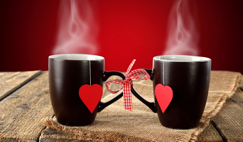 Две чашки горячего чая связаны бантом 