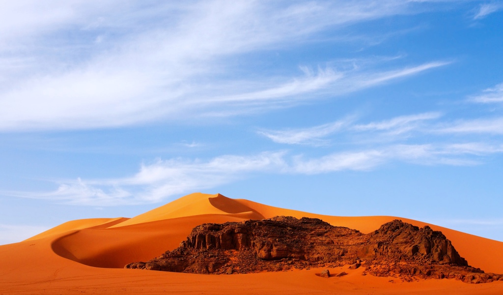 Orange hot Sahara desert under the blue sky