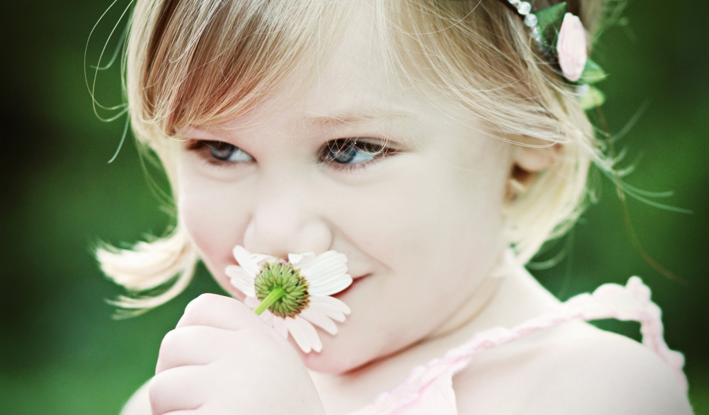 Милая девочка с красивыми глазами с ромашкой