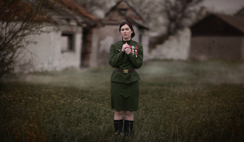 A girl in a tunic with military awards for May 9, retro