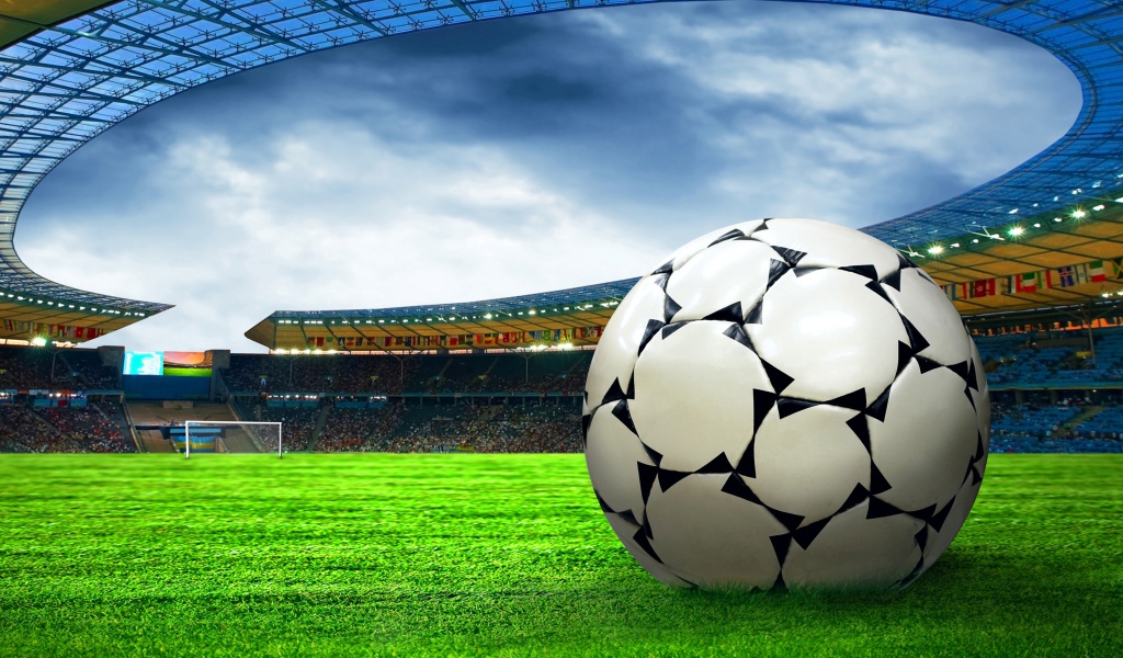 Футбольный мяч на зеленой траве стадиона