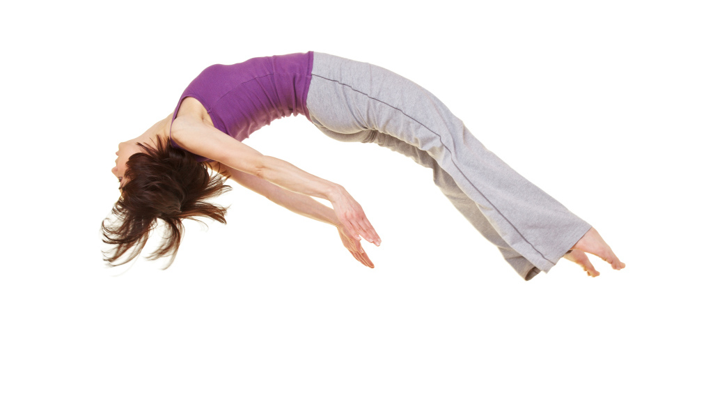 Спортивная девушка в невесомости на белом фоне