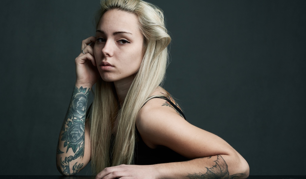 Young girl with white hair with tattoos on her body