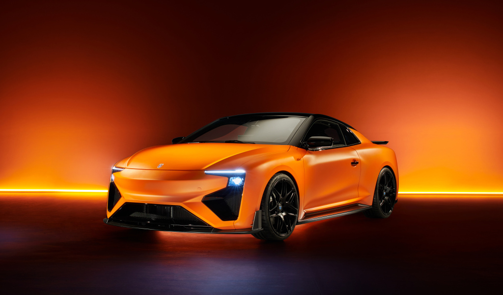 Оранжевый автомобиль Gumpert RG Nathalie 2019 года с включенными фарами