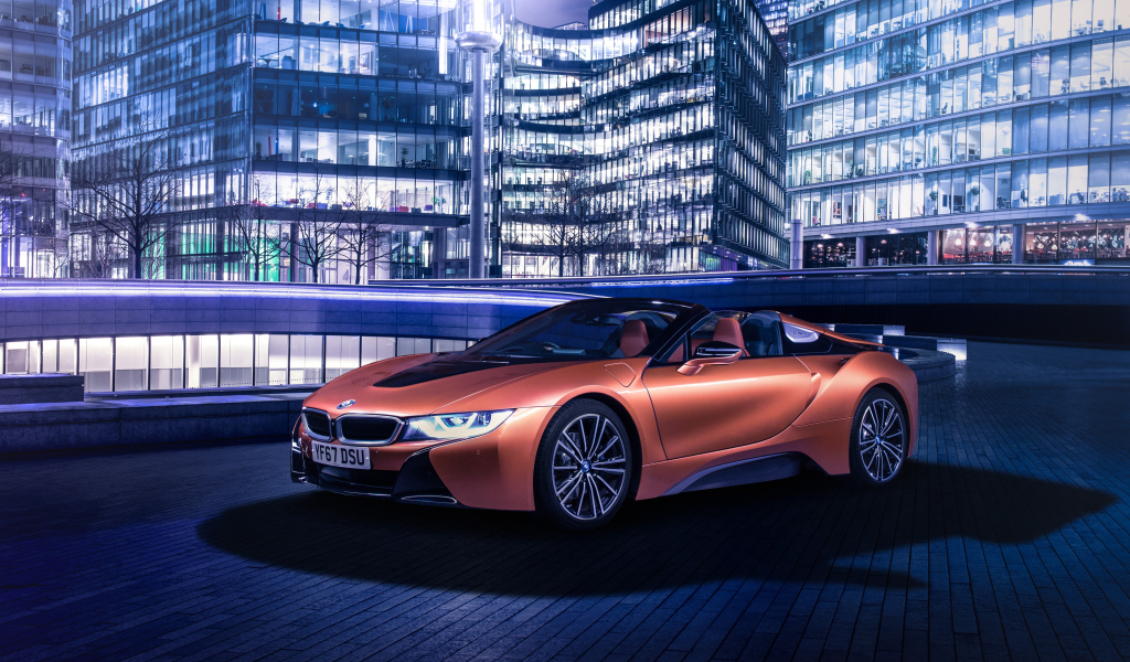 Дорогой оранжевый автомобиль BMW i8 на фоне здания