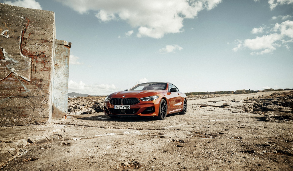Красный автомобиль BMW 8 под голубым небом