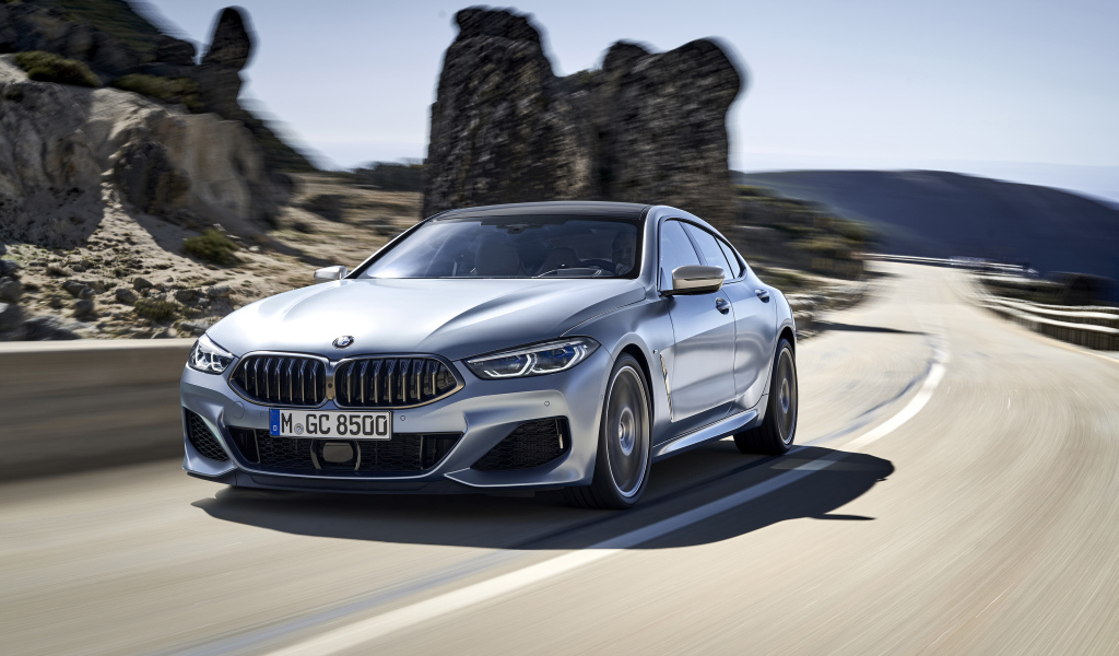 Серебристый автомобиль BMW M850i XDrive Gran Coupe, 2019 года на трассе