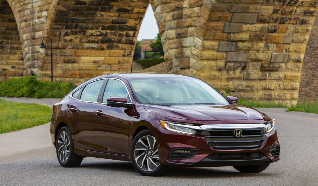 Бордовый автомобиль Honda Insight у моста