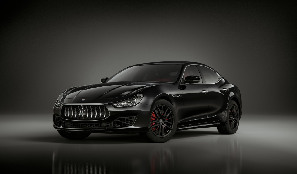 Черный дорогой автомобиль Maserati Ghibli Ribelle 2018 года на сером фоне