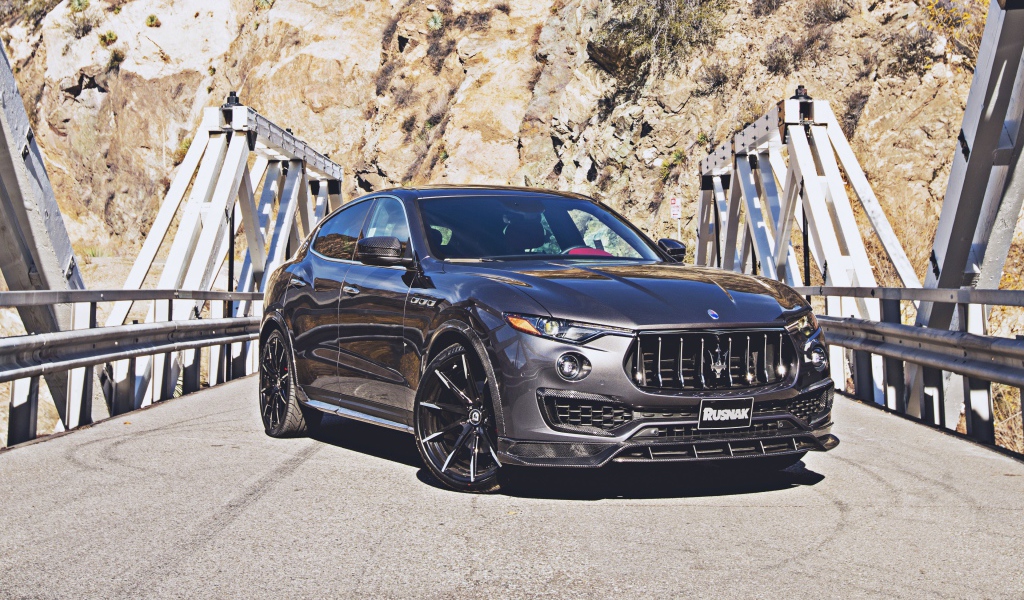SUV Maserati Levante on the bridge in the background of the mountains