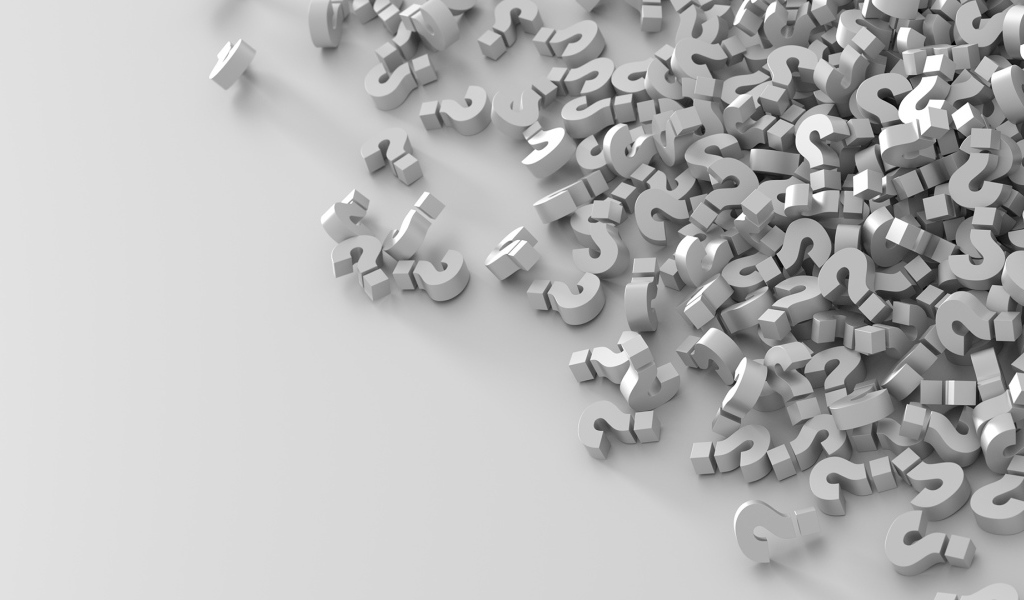 Много знаков вопроса на серой поверхности 