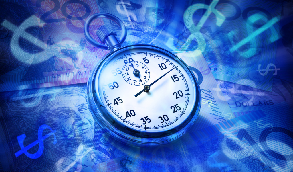 Секундомер лежит на купюрах разных стран 