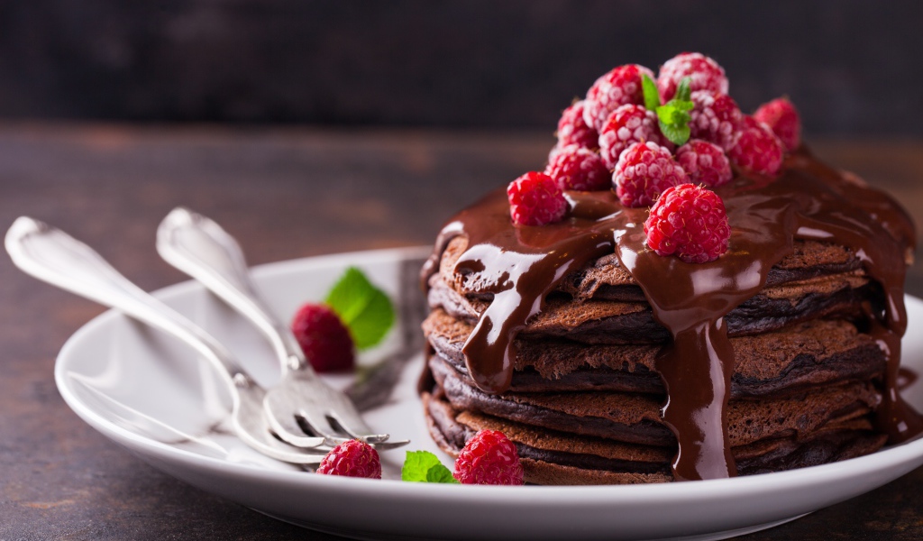 Chocolate Pancakes on a Plate with Chocolate and Raspberry Berries