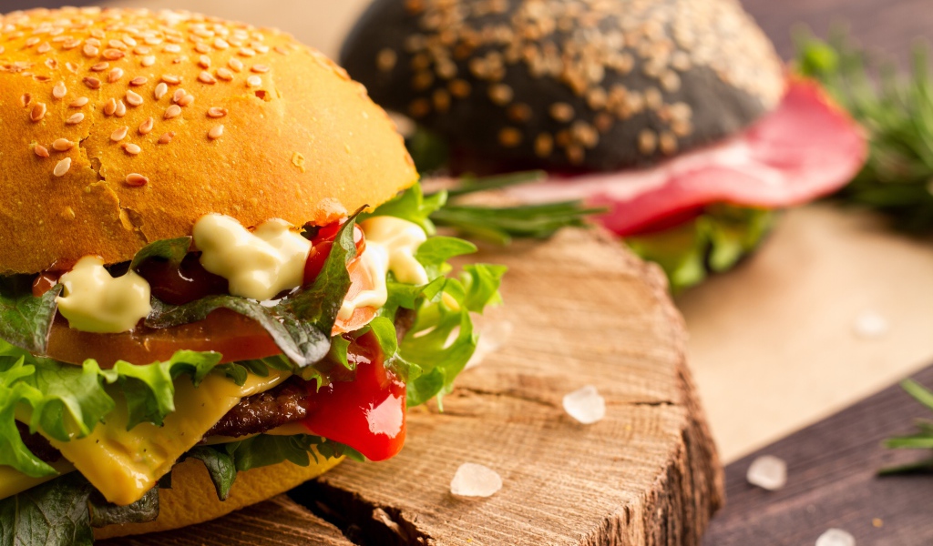 Гамбургер на деревянной доске крупным планом