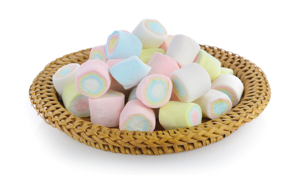 Маршмеллоу в корзинке на белом фоне