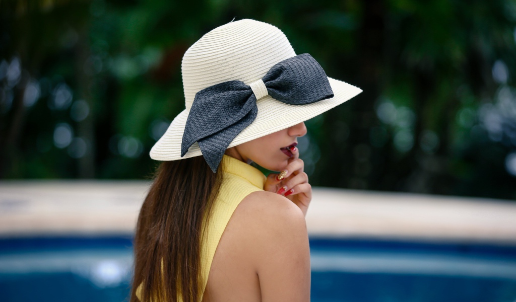 Красивая девушка в белой шляпе с серым бантом