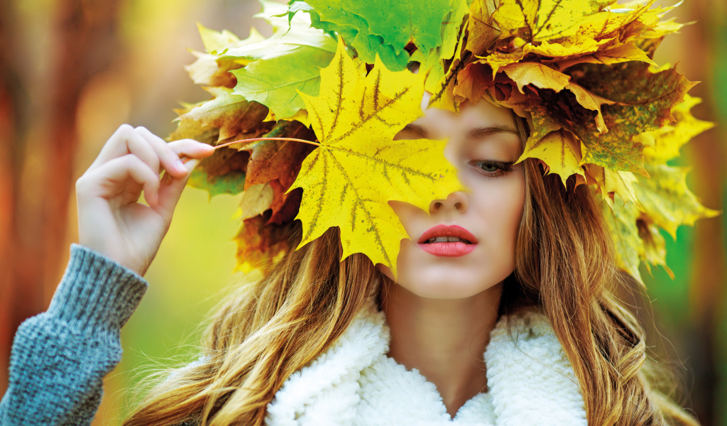 Красивая девушка с венком из листьев осенью