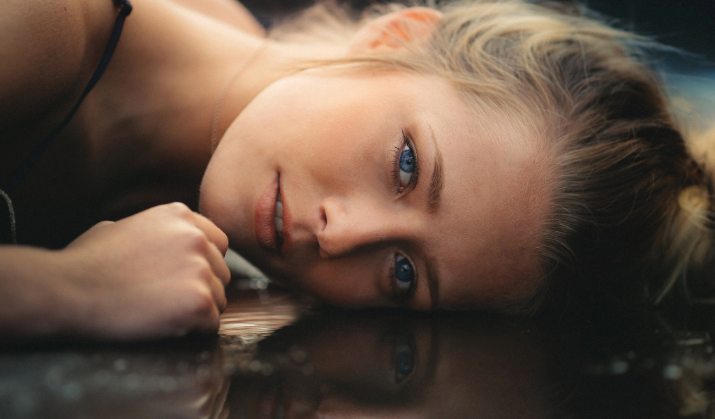 Голубоглазая девушка модель лежит на полу