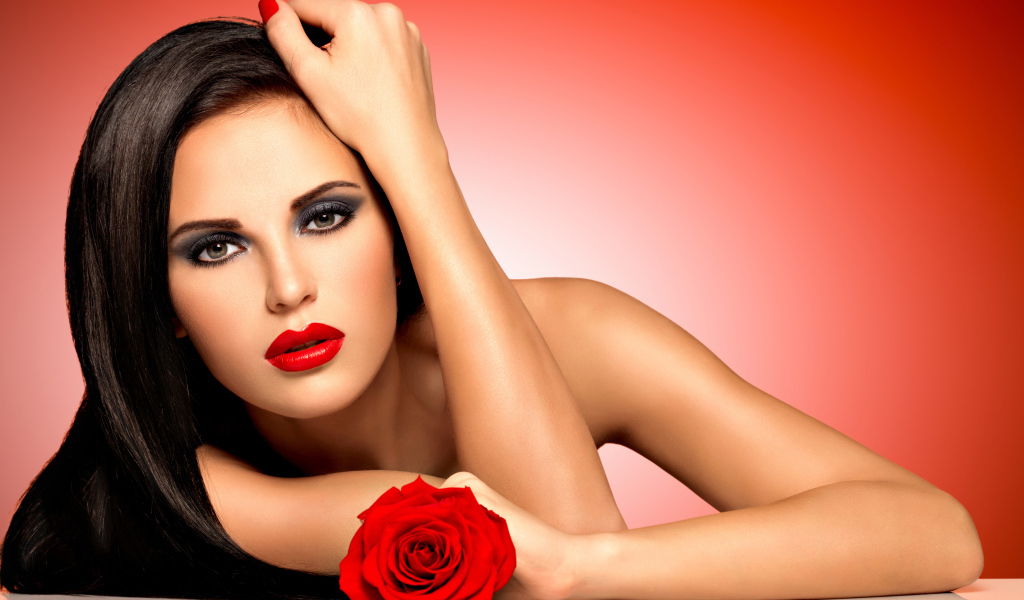 Молодая девушка с красной розой на красном фоне