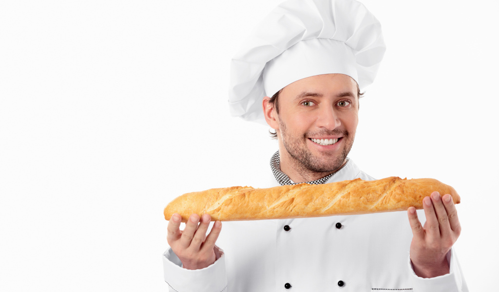 Мужчина повар в костюме с батоном в руках 
